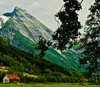 Image of a tall, rock-faced mountain in Norway