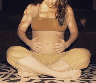 A pregnant woman doing prenatal yoga, concerned about weight gain in pregnancy.