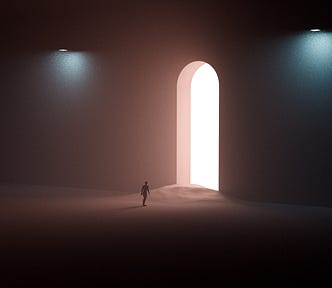 A person walking towards a bright white opening in a dark room filled with sand.