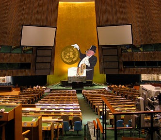 The UN plenary chamber, seen from the very back. At the dias stands an ogrish caricature of a capitalist, chomping a cigar and wearing a top hat. The capitalist stands behind a control box and is yanking on a lever in the form of a gilded dollar-sign. Between a white-gloved finger and thumb he dangles the UN logo that normally sits on the wall behind him. Image: ChrisErbach (modified) https://commons.wikimedia.org/wiki/File:UnitedNations_GeneralAssemblyChamber.jpg CC BY-SA 3.0 https://creative