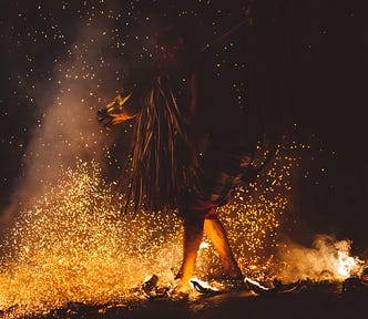Picture of a Shaman around a blazing fire.