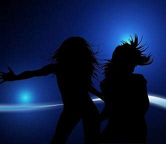 Women dancing, blue background, lights, movement