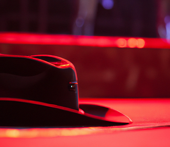 A cowboy hat on a stage under red lights.