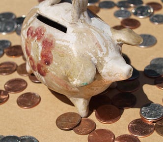 Piggy bank surrounded by loose coins