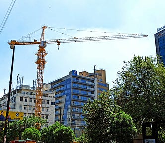 A crane against the background of buildings in a city