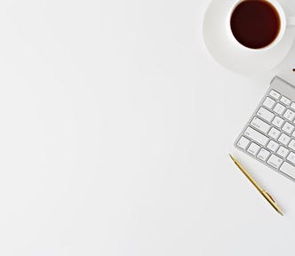 Minimalist keyboard and coffee cup — representing minimalist research