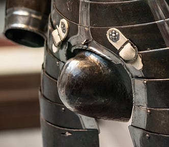 A detail of a suit of armour, showing a short but girthy codpiece.