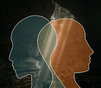 Two silhouettes facing opposite direction, overlapping over a darkly lit cave background