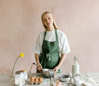White woman with long blond hair with baking implements