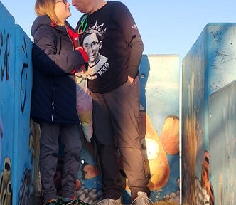 The author and her 10-year-old kid Daxton at the top of a lookout point having a staring contest.