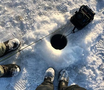 looking down an ice fishing hole