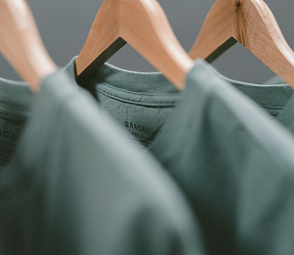 Photograph of gray T-Shirts on hangers