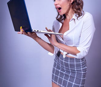 Surprised Woman Holding a Laptop