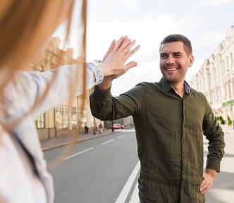 Man giving a high five to a woman