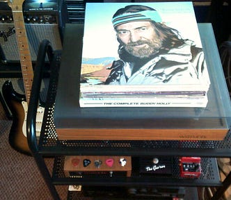 Stack of vinyl long playing records with Willie Nelson’s ‘A Whiter Shade Of Pale’ lying on top of a Hi-Fi System record deck in a music room