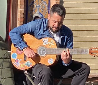 Guitarist and busker performing in Seville, Spain