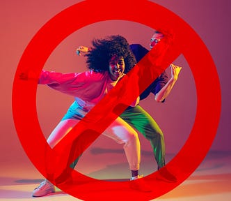 Two dancers with a “banned” symbol in front of them.