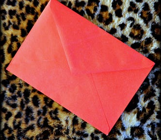 The back of a red Hallmark envelope.