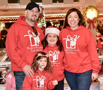 The writer and his family dressed in matching toy drive sweatshirts.