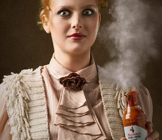 Stylized portrait of woman holding smoking tabasco sauce