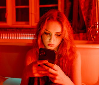 Sad Woman with Smudge on Face Holding Cellphone. When and how to stop counting calories before your mental health and relationship with food are ruined