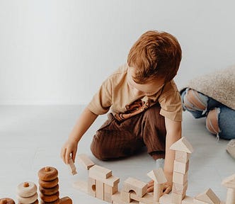 Picture of a boy stacking up blocks.