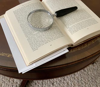 My photo of a book with a magnifying glass and red pen