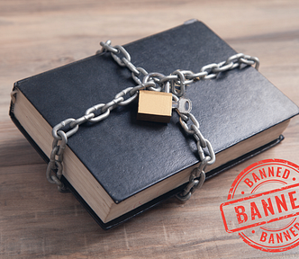 A black book wrapped in chains secured by a padlock, banned stamp in right corner
