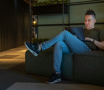A guy working on his laptop late at night.