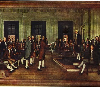 Color painting of numerous men, both standing and seated, with George Washington prominently standing at the front of the room.