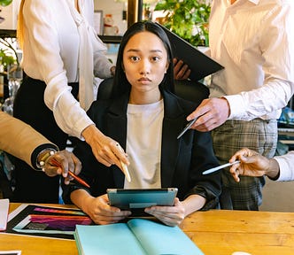 Woman Using Ipad Brainstorming with Her Colleagues