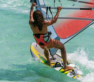 woman windsurfing in ocean — capable and strong
