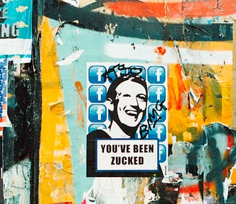 Wall of Graffiti with Mark Zuckerberg’s face over many Facebook logos, and text reading “You’ve Been Zucked.”