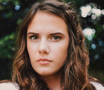 A young lady looking stern and angry.