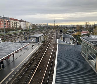 Berlin and the Fernsehturm in the background taken from a bridge above a train station