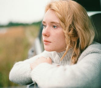 woman looking outside of her car