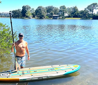 Gentry Bronson standing in the water just before he stand-up paddleboards down Bayou St. John in New Orleans