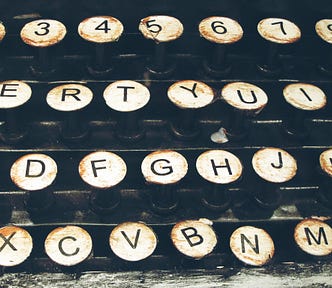 Closeup of middle keys on an old typewriter, slightly bent out of shape