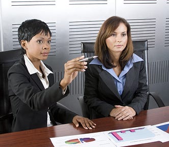 Multi-racial business team working within an office with a sales graphs