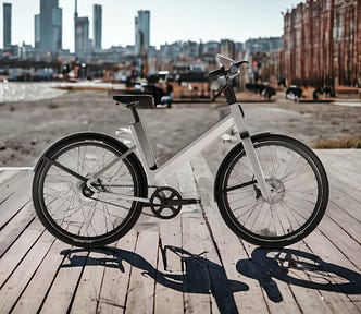 A view of the Anod Tribrid Electric Bike on display in an urban setting.