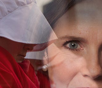 One of Margaret Atwood’s Handmaids is overlayed with Amy Coney Barrett’s eyes.