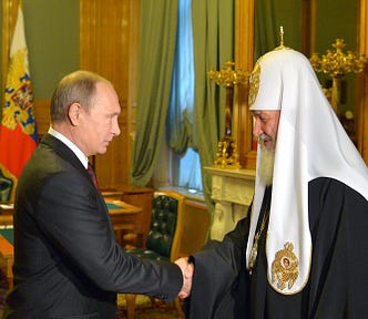 Vladimir Putin and Patriarch Kirill of Russia shaking hands