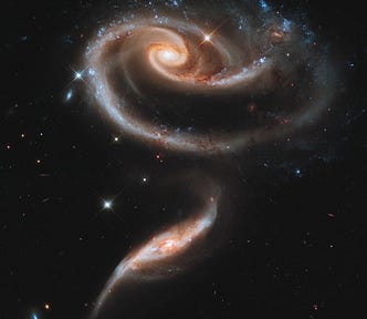 A pair of interacting galaxies called Arp 273 by NASA, ESA and the Hubble Heritage Team, originally pulled by the author from the Astropix collection. The larger, top galaxy is a spiral, similar to our own Milky Way while the smaller one at the bottom is more elliptical. Both show signs of signs of distortion due to their interactions with each other.