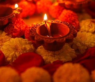 Earthen lamp amid marigold flowers