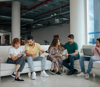 five people sat on a sofa