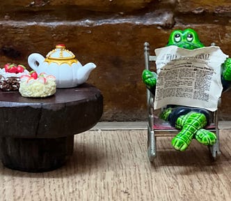 Crocodile reading a newspaper with tea on the table next to him