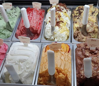 Vats of ice cream of various flavors.