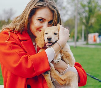 Woman holding a cute puppy.