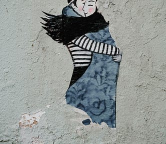 Two people hugging each other