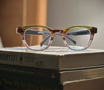 my new striped glasses resting on a set of books